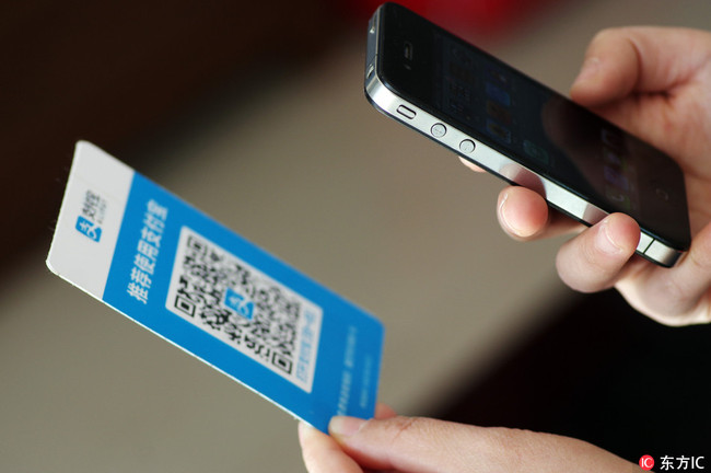 A Chinese mobile phone user scans a QR code via mobile payment service Alipay of Alibaba Group on his smartphone in Jinan city, east China's Shandong province, 16 March 2018.[Photo: IC]