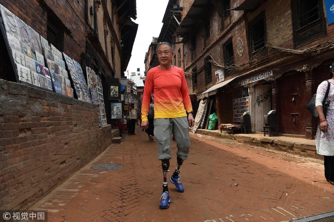 Chinese double amputee climber Xia Boyu walks in Bhaktapur on the outskirts of Kathmandu on April 4, 2018, ahead of his fifth attempt to climb the mountain. 