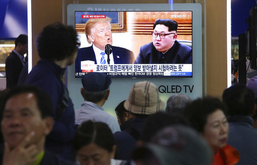 People watch a TV screen showing file footage of U.S. President Donald Trump, left, and North Korean leader Kim Jong Un during a news program at the Seoul Railway Station in Seoul, South Korea, Wednesday, May 16, 2018.[Photo: AP]