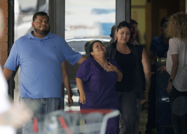 People react as they leave the family unification center at the Alamo Gym, following a shooting at Santa Fe High School Friday, May 18, 2018, in Santa Fe, Texas. [Photo: AP /David J. Phillip]