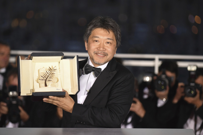 Director Hirokazu Kore-eda holds the Palme d'Or for the film 'Shoplifters' following the awards ceremony at the 71st international film festival, Cannes, southern France, Saturday, May 19, 2018. [Photo: Invision/AP/Arthur Mola]