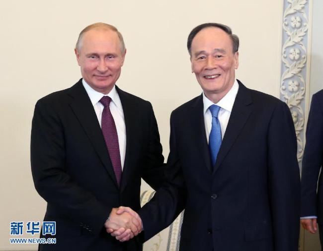 Russian President Vladimir Putin meets with Chinese Vice President Wang Qishan in St Petersburg on Thursday, May 24, 2018. [Photo: Xinhua]