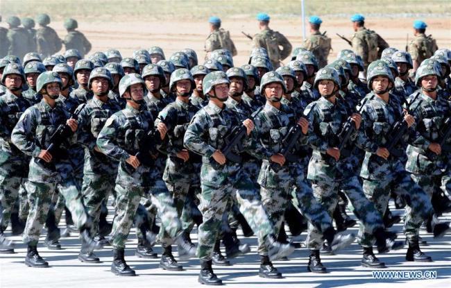 People's Liberation army soldiers participate in the opening ceremony of joint exercise code-named "Peace Mission 2014" involving member states of the Shanghai Cooperation Organization (SCO) in Zhurihe, north China's Inner Mongolia Autonomous Region, Aug. 24, 2014. The 18th Shanghai Cooperation Organization (SCO) Summit is scheduled for June 9 to 10 in Qingdao, a coastal city in east China's Shandong Province. [Photo: Xinhua]