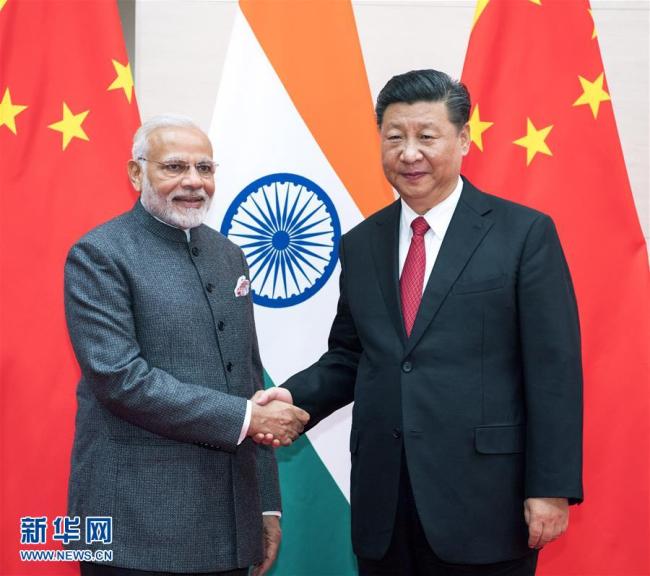 Chinese President Xi Jinping (R) meets with Indian Prime Minister Narendra Modi in Qingdao, east China's Shandong Province, June 9, 2018. [Photo: Xinhua]