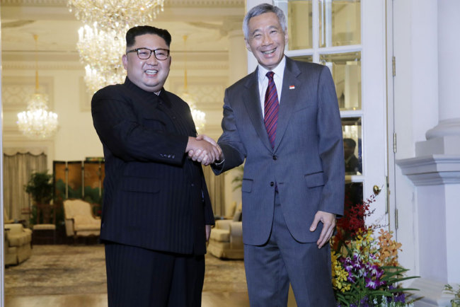 North Korean leader Kim Jong Un meets with Singapore's Prime Minister Lee Hsien Loong at the Istana or presidential palace on Sunday, June 10, 2018, in Singapore. [Photo: AP/Wong Maye-E]