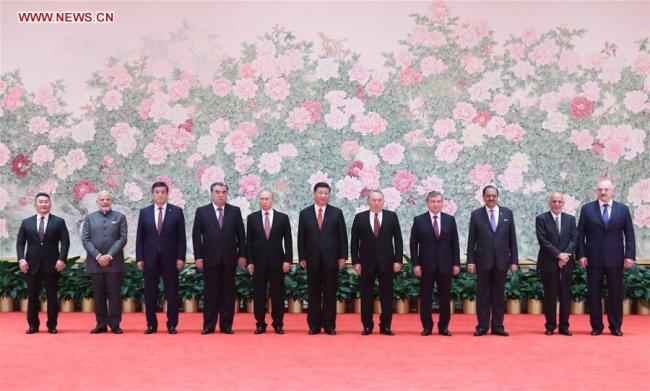 Chinese President Xi Jinping (C) and other leaders attending the 18th Shanghai Cooperation Organization (SCO) summit pose for a group photo ahead of a banquet in Qingdao, east China's Shandong Province, June 9, 2018.[Photo: Xinhua] 