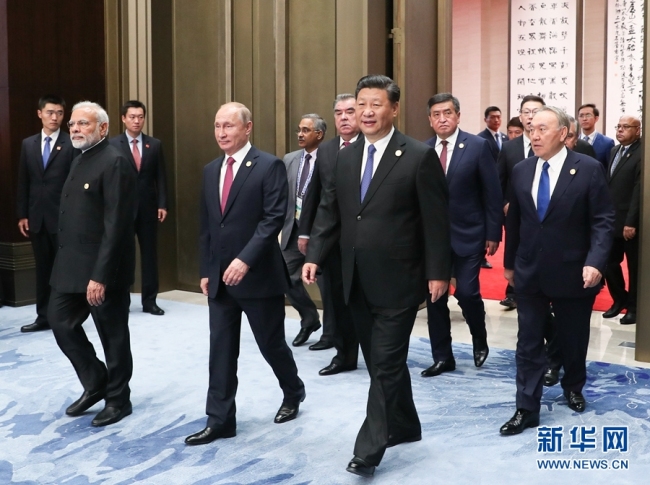 Leaders of the SCO member states enter the conference hall for a restricted session of the 18th Shanghai Cooperation Organization (SCO) summit in Qingdao on Sunday, June 10, 2018. [Photo: Xinhua]