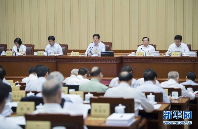 Li Zhanshu (C, back), chairman of the National People's Congress (NPC) Standing Committee, attends a plenary meeting of China's top legislature's ongoing bimonthly session in Beijing on Wednesday, June 20, 2018. [Photo: Xinhua]