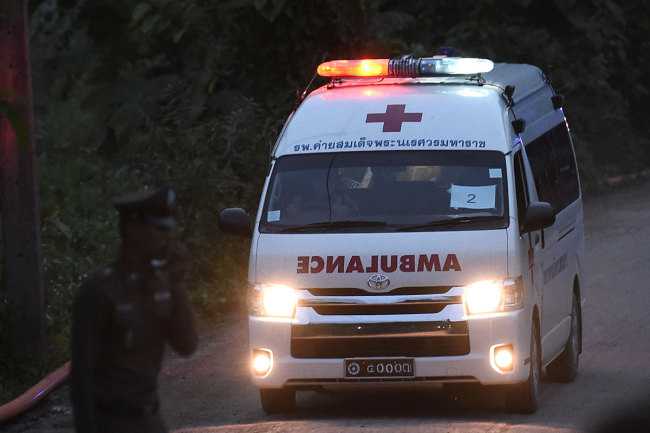 An ambulance exits from the Tham Luang cave area as rescue operations continue for those still trapped inside the cave in Khun Nam Nang Non Forest Park in the Mae Sai district of Chiang Rai province on July 9, 2018. [Photo: AFP/Ye Aung Thu]