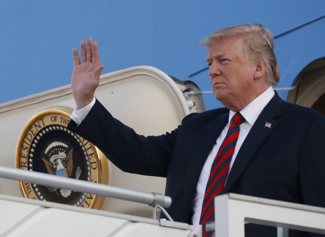 U.S. President Donald Trump waves as he arrives at the airport in Helsinki, Finland, Sunday, July 15, 2018 on the eve of his meeting with Russian President Vladimir Putin. [Photo: AP/Pablo Martinez Monsivais]