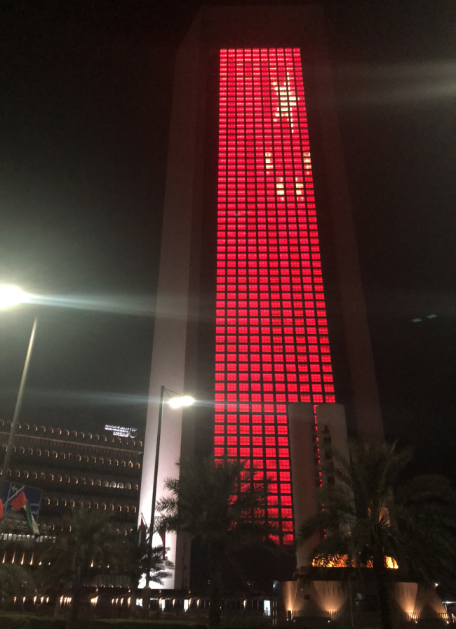 Abu Dhabi National Oil Company Headquarter lights up red to welcome the state visit of Chinese President Xi Jinping. [Photo: China Plus]