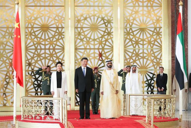 Chinese President Xi Jinping, his wife Peng Liyuan and the United Arab Emirates (UAE) Vice President and Prime Minister Sheikh Mohammed bin Rashid Al Maktoum are seen on a reviewing stand in Abu Dhabi, the UAE, July 19, 2018. Xi arrived here on Thursday for a state visit to the UAE. The UAE's vice president hosted a welcome ceremony for the Chinese president at the airport. [Photo: Xinhua/Xie Huanchi]