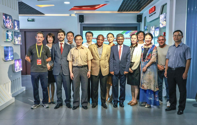 Foreign diplomats and management staff with the China National Theatre for Children pose for a photo on Friday as they announced that twelve children's dramas from the BRICS countries will soon be staged in Beijing.[Photo: China Plus]