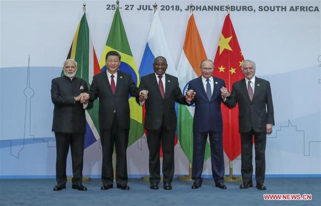 Chinese President Xi Jinping (2nd L), Brazilian President Michel Temer (1st R), Russian President Vladimir Putin (2nd R), Indian Prime Minister Narendra Modi (1st L) and South African President Cyril Ramaphosa pose for a group photo during the Plenary Session of the 10th BRICS summit in Johannesburg, South Africa, July 26, 2018. [Photo: Xinhua/Xie Huanchi]