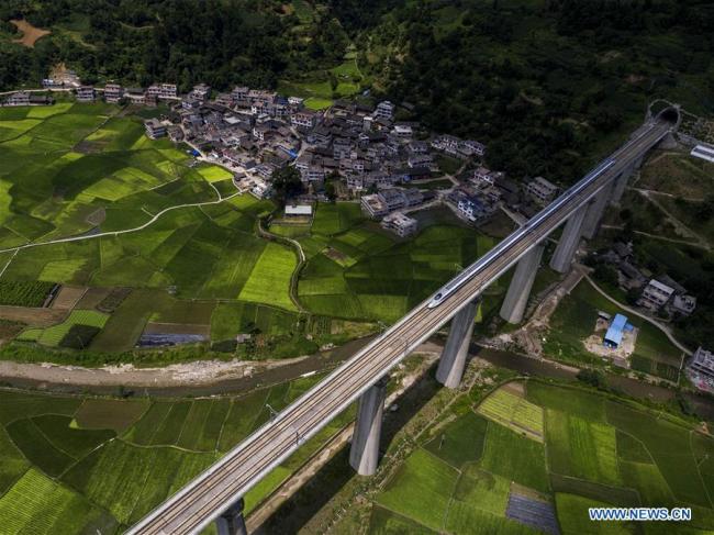 Aerial photo taken on June 22, 2016 shows a bullet train running on a bridge of Shanghai-Kunming high-speed railway in southwest China's Guizhou Province. (Xinhua/Wu Jibin)