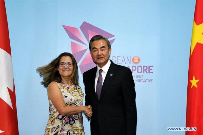 Chinese State Councilor and Foreign Minister Wang Yi (R) meets with Canadian Foreign Minister Chrystia Freeland in Singapore, Aug. 3, 2018. [Photo: Xinhua]