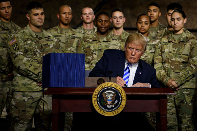 US President Donald Trump signs the "John S. McCain National Defense Authorization Act for Fiscal Year 2019" at Fort Drum, New York, on August 13, 2018. [Photo: AFP/Brendan Smialowski]