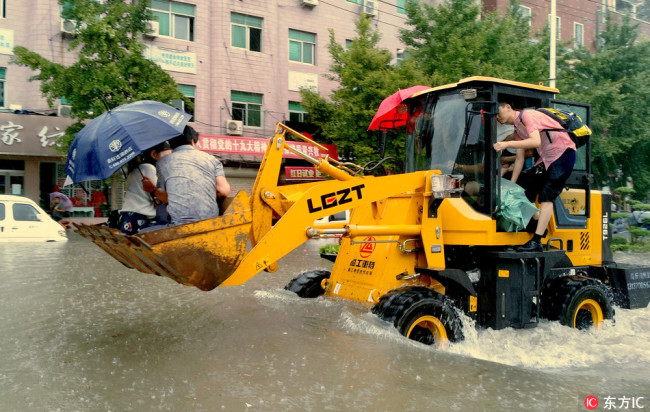 Armored wheel loaders are on the way to evacuate local residents in floodwater after a heavy rainstorm caused by Typhoon Rumbia in central China's Henan province, August 18, 2018. [Photo: IC]