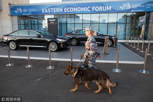 A security guard patrols with a dog outside the venue ahead of the Eastern Economic Forum in Vladivostok, Russia, on Monday, Sept. 10, 2018. [Photo: Bloomberg via Getty Images/Andrey Rudakov]