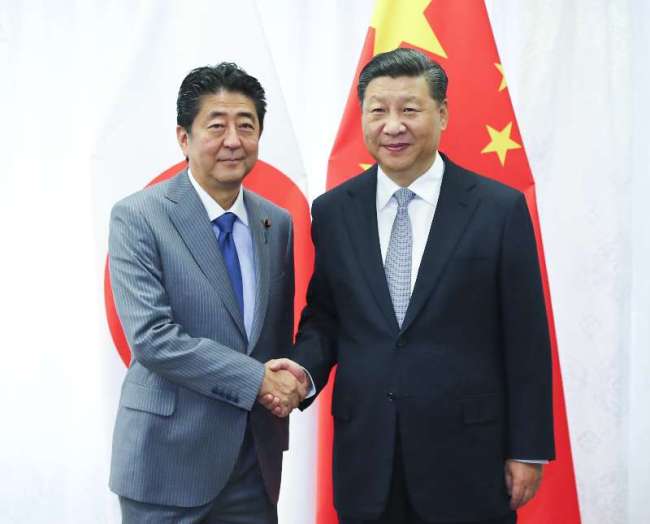 Chinese President Xi Jinping and Japanese Prime Minister Shinzo Abe meet on Wednesday, September 12, 2018, on further improving bilateral ties and shouldering joint responsibility in promoting global and regional peace and stability, as well as development and prosperity.[Photo: Xinhua]