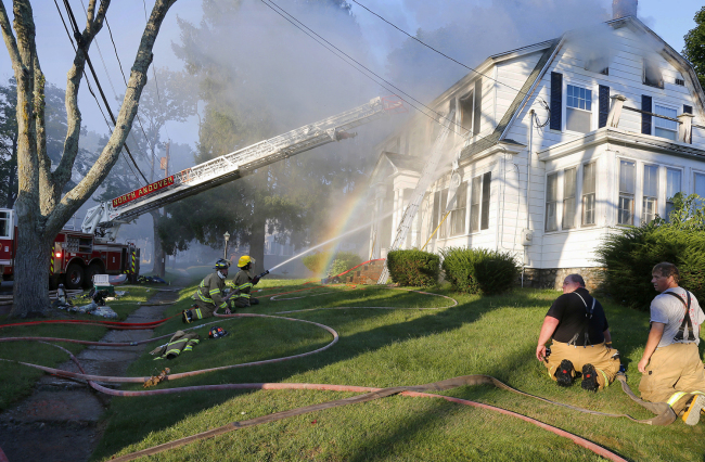 Firefighters battle a house fire, Thursday, Sept. 13, 2018, on Herrick Road in North Andover, Mass., one of multiple emergency crews responding to a series of gas explosions and fires triggered by a problem with a gas line that feeds homes in several communities north of Boston. [Photo: Ap/Mary Schwalm]