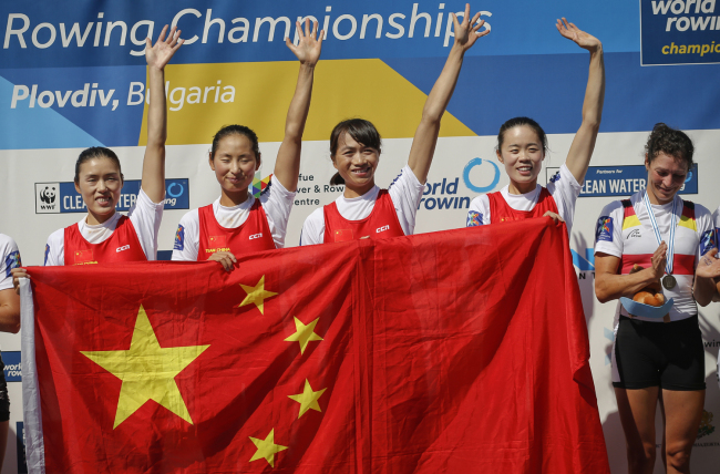 Gold medalists of China's team wave from the podium after winning the Lightweight Women's Quadruple Sculls at the World Rowing Championships in Plovdiv, Bulgaria, Friday, Sept. 14, 2018. [Photo: AP/Darko Vojinovic]