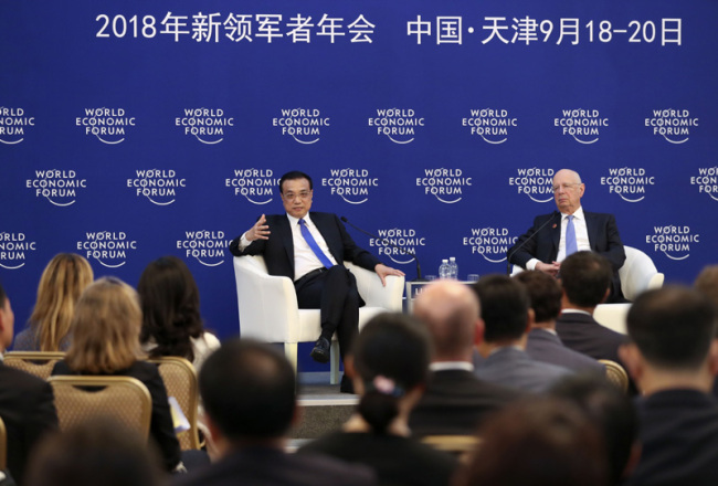 Chinese Premier Li Keqiang holds a dialogue with representatives from communities such as industry and commerce, finance, think tanks and media outlets attending the Summer Davos 2018 in Tianjin on September 20, 2018. [Photo: gov.cn]