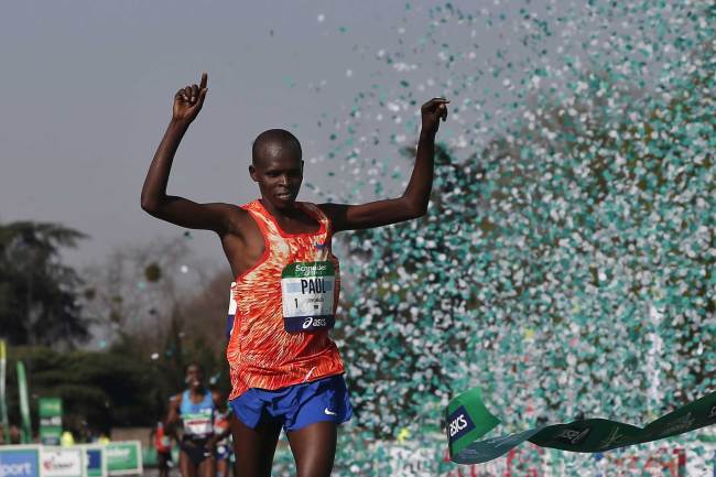 Kenya's Paul Lonyangata celebrates as he crosses the finish line to win the 42nd Paris Marathon men's race, in Paris, Sunday, April 8, 2018. [Photo: AP/Thibault Camus]