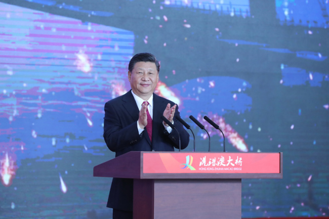 Chinese President Xi Jinping, also general secretary of the Communist Party of China Central Committee and chairman of the Central Military Commission, announces the opening of the Hong Kong-Zhuhai-Macao Bridge at an opening ceremony in Zhuhai, south China's Guangdong Province, Oct. 23, 2018. [Photo: Xinhua/Ju Peng]