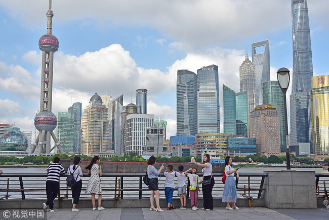 Tourists visit the Bund in Shanghai on July 12, 2018. [File photo: VCG]