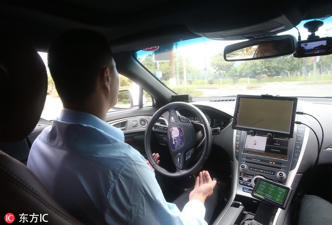 A self-driving taxi on the road in Guangzhou, Guangdong Province, seen here on Thursday, November 1, 2018. [Photo: VCG] 