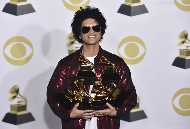 Bruno Mars poses in the press room with his awards for best R&B album, record of the year, album of the year, best engineered album, non-classical, for "24K Magic," and song of the year, best R&B performance and best R&B song, for "That's What I Like" at the 60th annual Grammy Awards at Madison Square Garden on Sunday, Jan. 28, 2018, in New York. [Photo: AP]