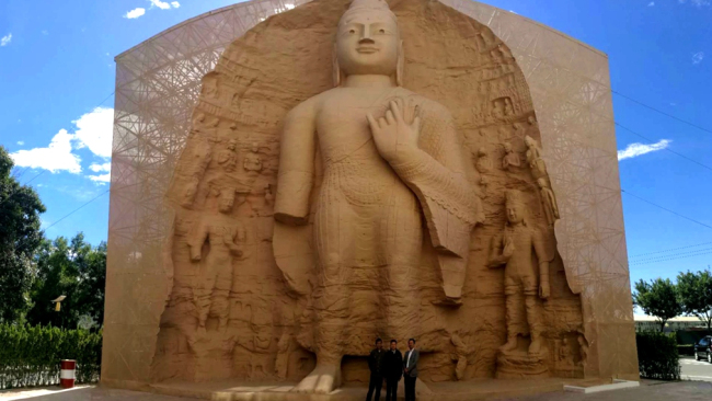 The replica of a Buddhist statue from the Yungang Grottoes stands on the campus of Beijing University of Civil Engineering and Architecture. [Photo:CGTN]