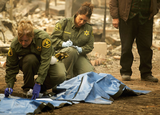Sheriff's deputies recover the bodies of multiple Camp Fire victims at the from a Holly Hills Mobile Estates residence on Wednesday, Nov. 14, 2018, in Paradise, Calif. [Photo: AP/Noah Berger]