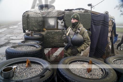A Ukrainian national guard soldier stands in position at the checkpoint in Berdyansk, south coast of Azov sea, eastern Ukraine, Tuesday, Nov. 27, 2018. Russia and Ukraine traded blame after Russian border guards on Sunday opened fire on three Ukrainian navy vessels and eventually seized them and their crews. The incident put the two countries on war footing and raised international concern.[Photo:AP]