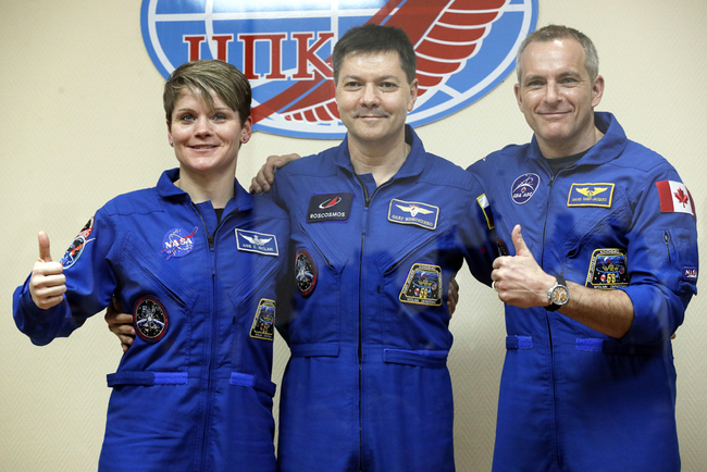 U.S. astronaut Anne McClain, Russian cosmonaut Oleg Kononenko‎ and Canadian astronaut David Saint Jacques pose during a news conference in Russian leased Baikonur cosmodrome, Kazakhstan, Sunday, Dec. 2, 2018. [Photo: AP/Dmitri Lovetsky]