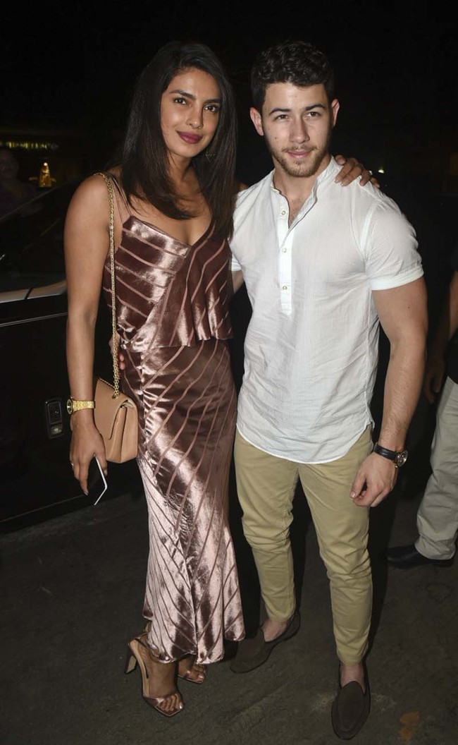 Indian actress Priyanka Chopra left, and US musician Nick Jonas pose for photographs as they arrive at a restaurant in Mumbai, India, Monday, Nov.26, 2018. [Photo: AP]