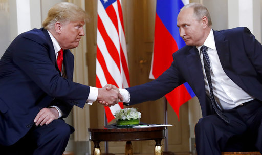 U.S. President Donald Trump, left, and Russian President Vladimir Putin shake hands at the beginning of a meeting at the Presidential Palace in Helsinki, Finland, on July 16, 2018. [File photo:AP]