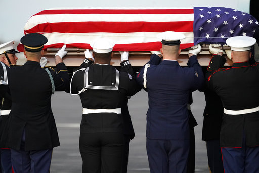 The flag-draped casket of former President George H.W. Bush is carried by a joint services military honor guard Wednesday, Dec. 5, 2018, at Ellington Field in Houston. [Photo: AP]