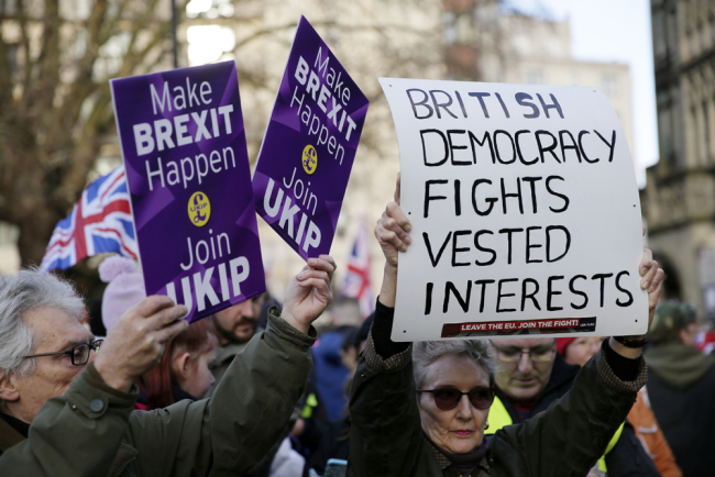 Demonstrators hold placards at the "Brexit Betrayal Rally", a pro-Brexit rally, on Park Lane in London, Sunday Dec, 9, 2018. [Photo: AP/Tim Ireland]