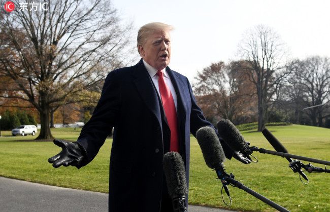 United States President Donald J. Trump answers questions from the press while departing the White House December 8, 2018 in Washington, DC. [Photo: IC]