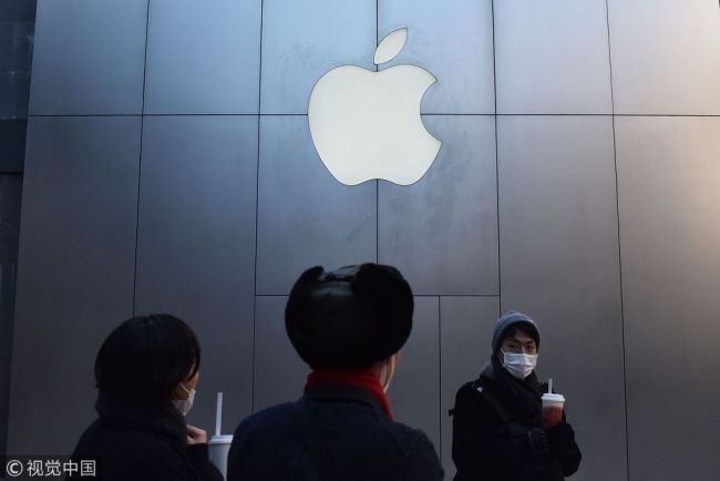 People walk past an Apple store in Beijing on Tuesday, December 11, 2018. [Photo: VCG]