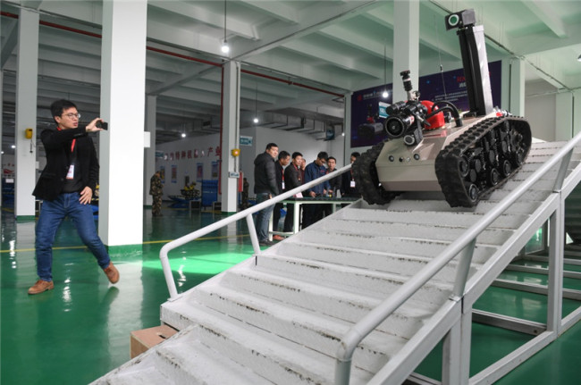 A firefighting robot climbs down stairs during a drill at a factory in Ningde, Fujian Province on Wednesday, December 12, 2018. [Photo: Xinhua]