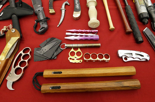 In this April 6, 2017, file photo, objects confiscated from passengers' carry-on luggage, including nunchucks, bottom, are displayed at Seattle-Tacoma International Airport in SeaTac, Wash. A federal court says New York's ban on nunchucks, the martial arts weapon made famous by Bruce Lee but prohibited in the state for decades, is unconstitutional under the Second Amendment. [File photo: AP]