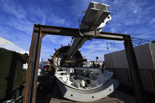 The "linestorm" second generation tunnel boring equipment is displayed before an unveiling event for the Boring Company Hawthorne test tunnel in Hawthorne, Calif., on Tuesday, Dec. 18, 2018. [Photo: Pool via AP/Robyn Beck]