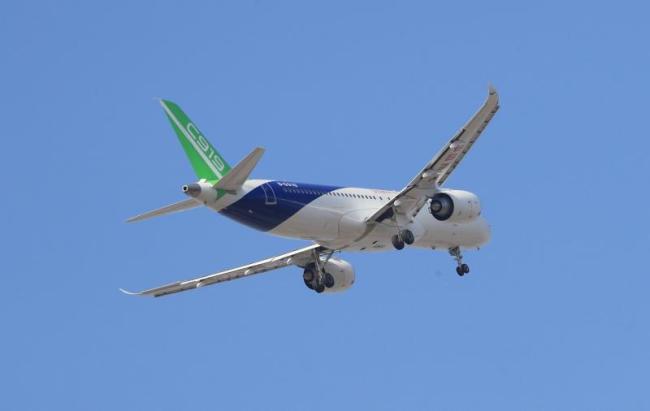 The third C919 aircraft flies over Pudong International Airport during its first flight on Friday, December 28, 2018. [Photo: People's Daily]
