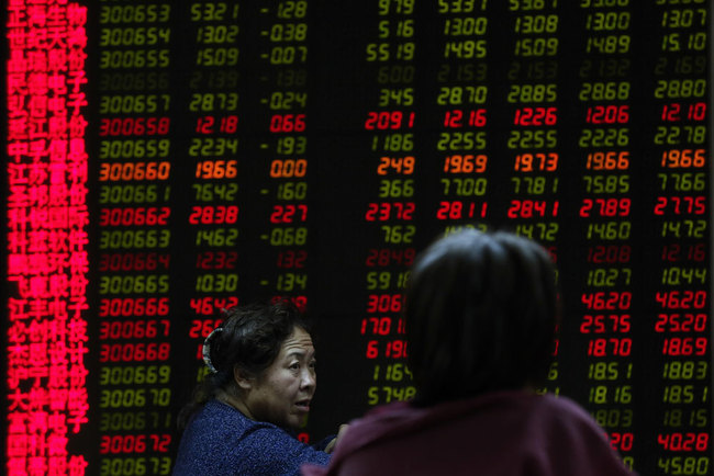 Women chat in front of an electronic board displaying stock prices at a brokerage house in Beijing, Friday, Dec. 14, 2018. Asian markets tumbled on Friday after China reported weaker-than-expected economic data, stirring up worries about the state of the world's second-largest economy. [Photo: AP]