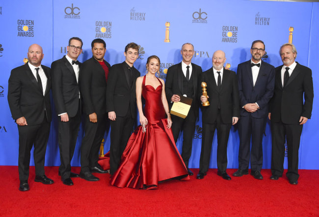 The cast and crew of "The Americans" pose in the press room with the award for best television series, drama at the 76th annual Golden Globe Awards at the Beverly Hilton Hotel on Sunday, Jan. 6, 2019, in Beverly Hills, Calif. [Photo: Invision/AP/Jordan Strauss]