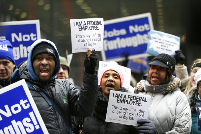 Government workers rally against the partial government shutdown at Federal Plaza, Thursday, Jan. 10, 2019, in Chicago. The partial government shutdown continues to drag on with hundreds of thousands of federal workers off the job or working without pay as the border wall fight persists. [Photo: AP]