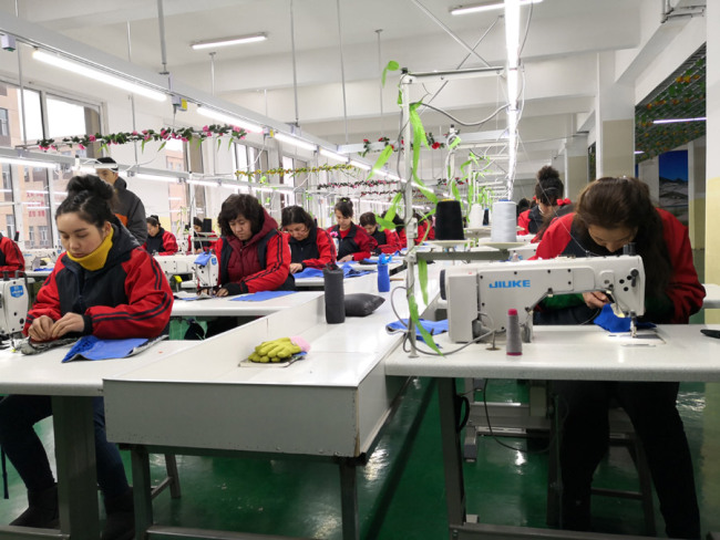 Students are practicing sewing. [Photo: China Plus]